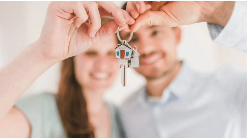 A couple holding their house key