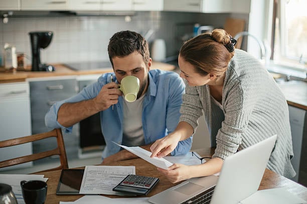 Photo of a young couple talks about home appraisal refinance