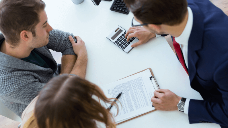 A broker explaining to a couple