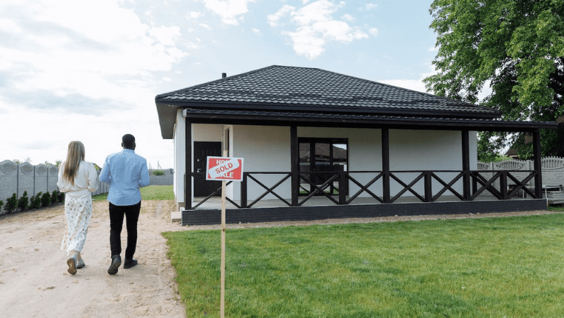 a couple going entering to a house that have been sold 
