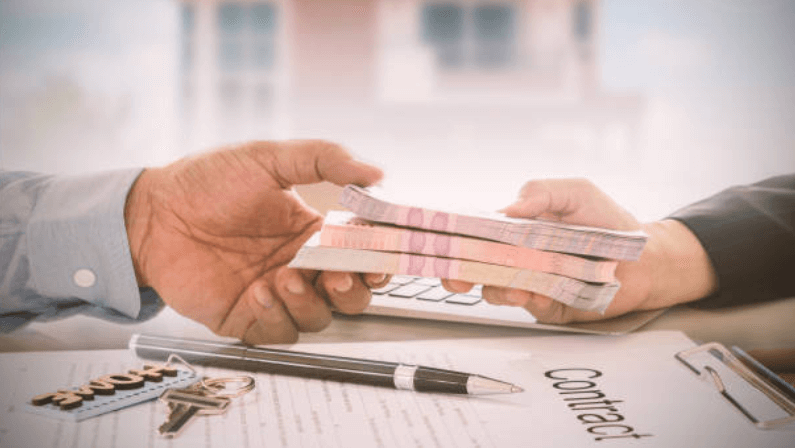 a man giving a down payment to a mortgage broker to buy a house