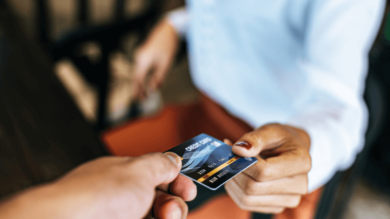 A man paying for his rent using a credit card