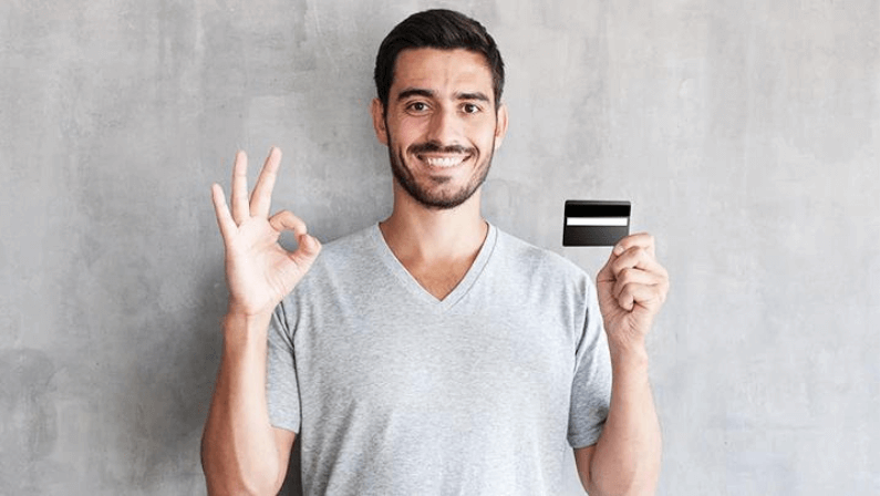 A man holding his credit card