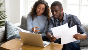 Couple reviewing mortgage term and loan amortization schedules