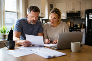 Canadian homeowners reviewing mortgage questions at their kitchen table in 2026